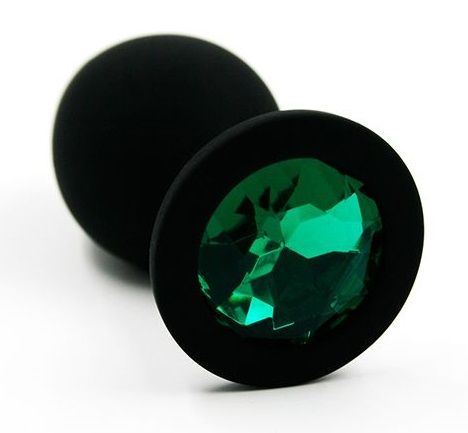 Анальная пробка из силикона черного цвета, размер M. Страз в основании круглой формы,  выполнен из стекла темно-зеленого цвета. Упакована в вельветовый мешочек для хранения. Вес - 46,5 граммов.