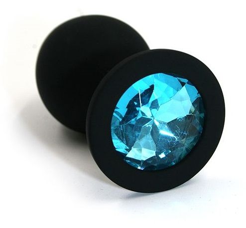 Анальная пробка из силикона черного цвета, размер M. Страз в основании круглой формы,  выполнен из стекла голубого цвета. Упакована в вельветовый мешочек для хранения. Вес - 46,5 граммов.