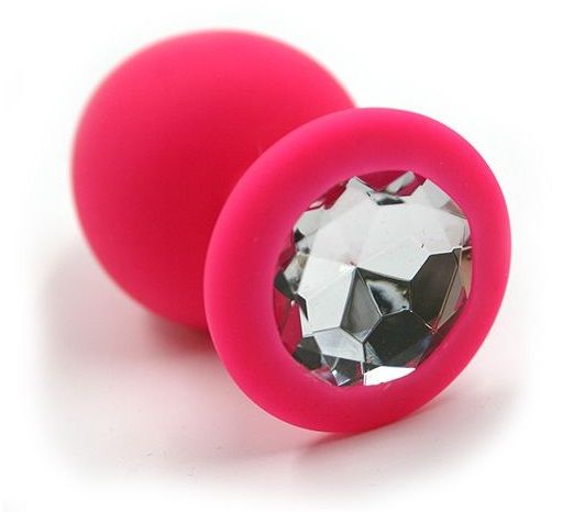 Анальная пробка из силикона розового цвета, размер M. Страз в основании круглой формы,  выполнен из прозрачного стекла. Упакована в вельветовый мешочек для хранения. Вес - 46,5 граммов.
