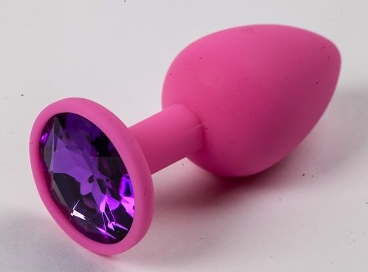 Розовая анальная пробка с фиолетовым кристаллом. Широкое основание позволяет максимально безопасно использовать этот интимный аксессуар.