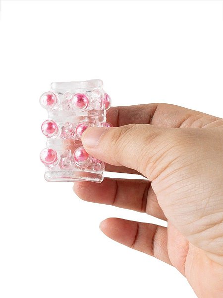 Сквозная насадка на пенис увеличит толщину полового члена мужчины и позволит его партнёрше испытать потрясающие эротические эмоции. Выпуклости с цветными шариками на поверхности изделия усилят возбуждение женщины. Интимный аксессуар изготовлен из эластичного материала. Хорошо мнётся и тянется. Подходит для пенисов разных размеров. Прост в применении и уходе. Внутренний диаметр - 2,5 см.